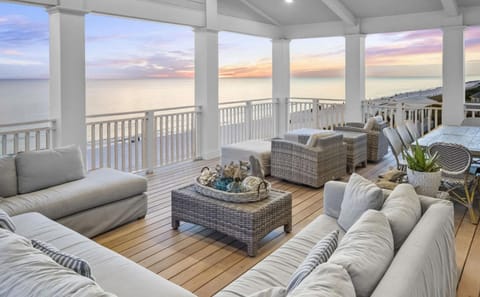 Expansive Oceanfront Terrace with Panoramic Gulf Views, Sunset Lighting, and Luxury Lounge Seating