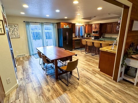 View of dining and kitchen from the living room with backyard access