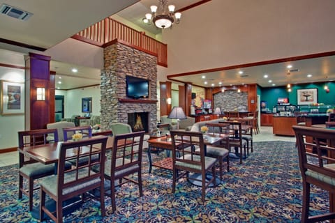 Spacious guest lounge with fireplace and comfortable seating.