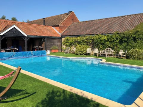 Shared outdoor heated swimming pool | Orchard House, Hempstead, near Holt