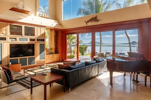 Relax in the luxurious living room which features floor to ceiling views of the bay and beyond to Lanikai.