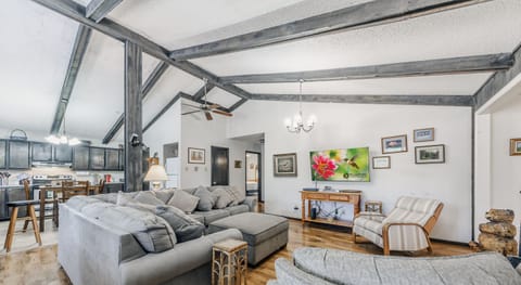 Main living room with high ceiling and flat screen TV
