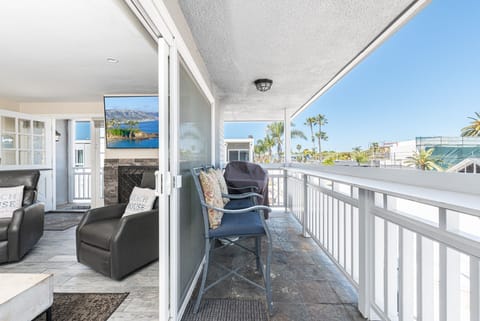 The front private balcony looks out onto a residential street and includes a propane grill.