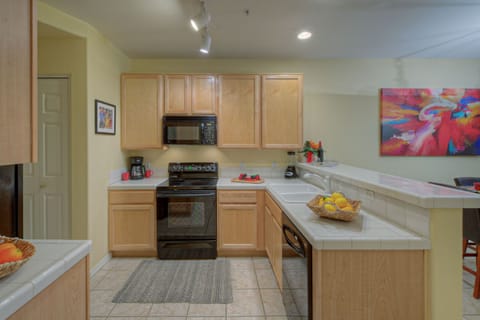 Laundry area and the door to the garage are in alcove adjoining kitchen.