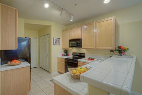 Open and bright kitchen is well stocked with everything you need to prepare your favorite cuisine.