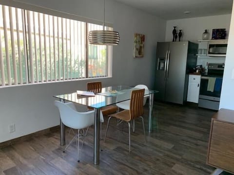 Large window in front of dining table.