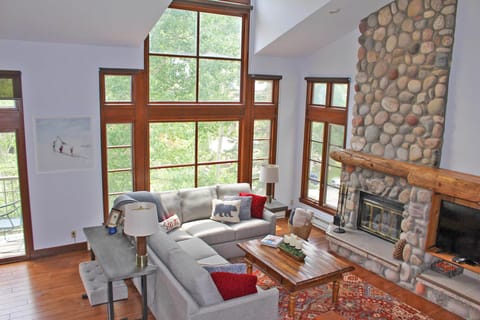 Great Room with wood burning fire place, TV, shuffle board and walkout deck