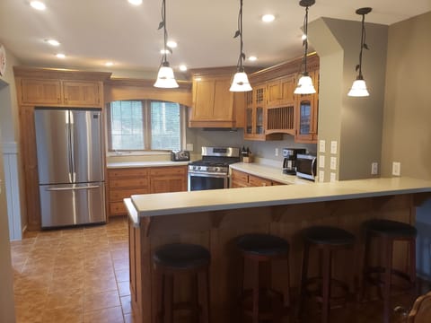 Kitchen with new appliances, breakfast bar area for 4