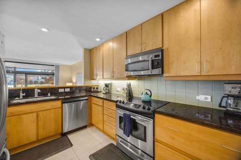Enjoy a bright kitchen with stainless steel appliances and warm wood cabinetry
