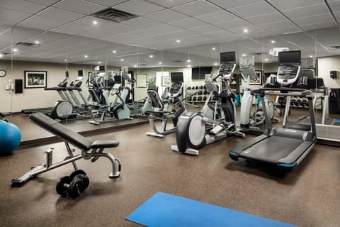 Fitness center equipped with various exercise machines and weights.