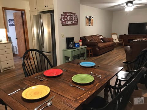 Dining room with coffee bar is open to a relaxed living room. 