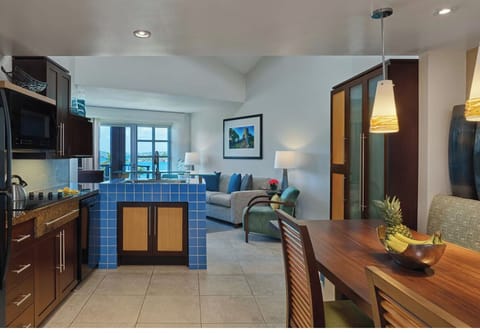 Kitchen and banquet dining with open duplex living space opening to terrace. 