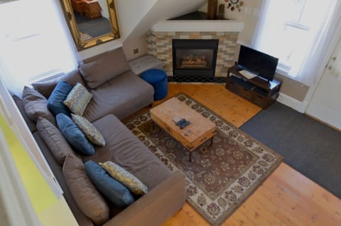 Living Room Area - The living room area has a comfortable sofa, a cozy fireplace, and a smart TV.