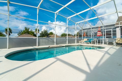 Screened in private pool with lounge seating.