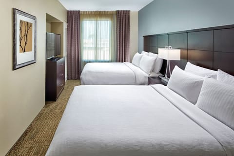 Bedroom with two queen beds and flat-screen TV.