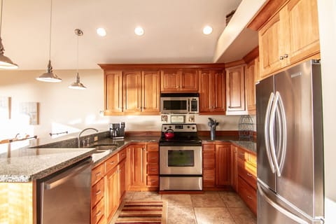 Enjoy cooking dinner in a fully equipped kitchen with stainless steel appliances.