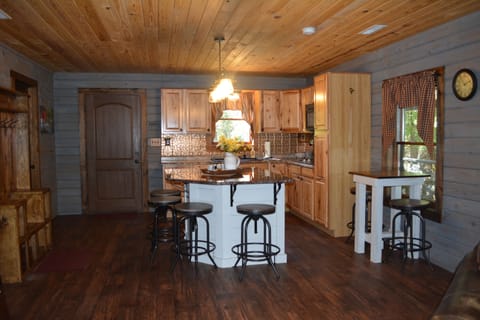 Kitchen area includes island with seating for 4, and cafe table that seats 2.