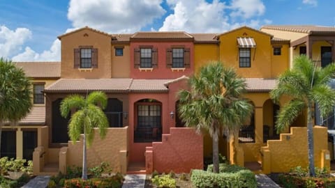 Front of townhome, walkup entry and front porch (reddish , middle home). 