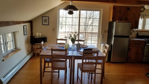 Dining room with balcony in the background