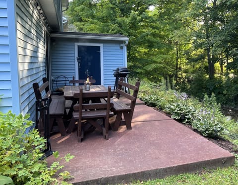Back patio with seating and grill overlooking creek