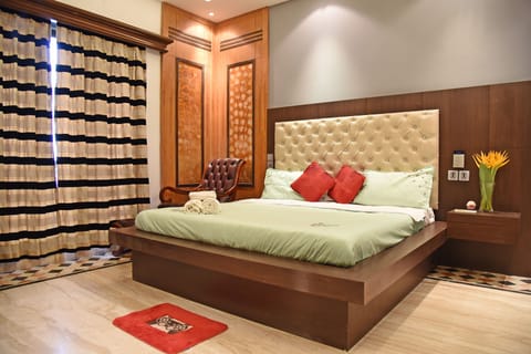 King Size Bed with International Sockets next to it. 