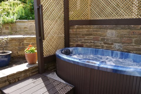 Hot tub just for two - covered so you can take a soak whatever the weather.