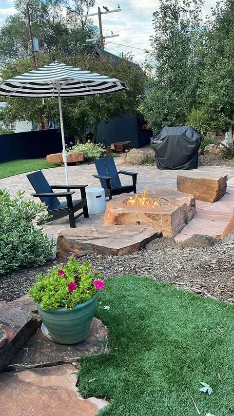 The backyard when fire pit and cornhole court is perfect for friends and family.