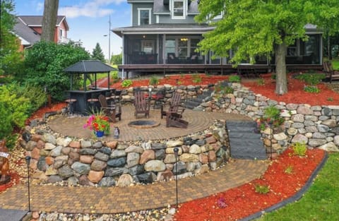 Lakefront area with Adirondack chairs, dining table,  tiki bar and fire pit!

