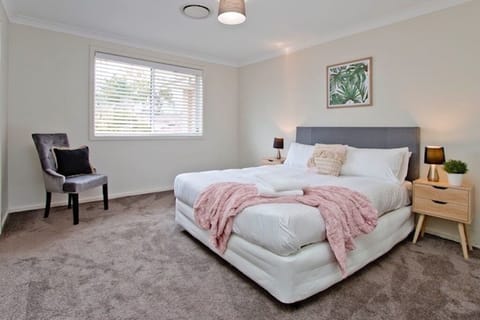 Master bedroom with queen bed and spare single mattress