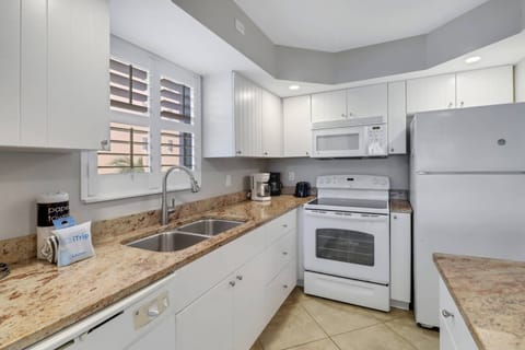 The bright and open kitchen has been updated with granite counters and full size appliances.
