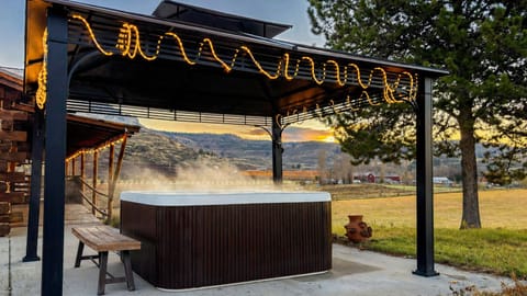 Soak in the hot tub with stunning valley and mountain views under the gazebo.