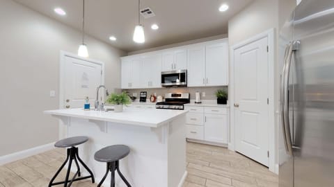 Fully stocked gourmet kitchen featuring extra seating at the bar