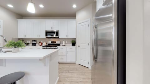 Fully stocked gourmet kitchen featuring stainless steel appliances
