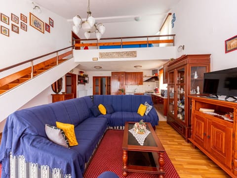 Couch, Furniture, Cabinetry, Property, Table, Interior Design, Orange, Studio Couch, Floor, Living Room