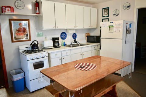 The full kitchen is supplied with dishes, utensils, pots & pans, & 2 dish towels