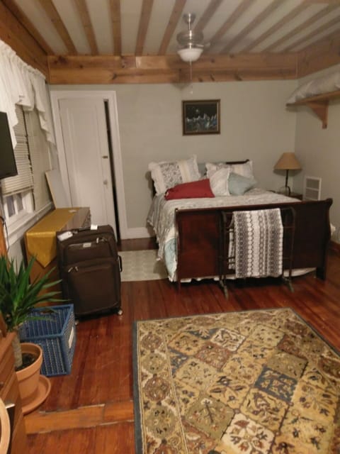 Bedroom with sleigh bed and custom woodwork also has TV 2 leather recliners desk
