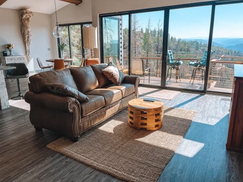 The comfortable living room space offers breathtaking views of the canyon below.