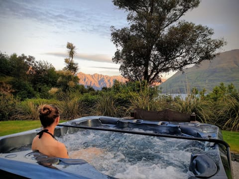 Relax in your private spa overlooking Lake Wakatipu and the Remarkables