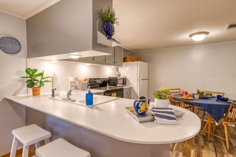 The light and bright kitchen is well stocked for all your cooking needs.