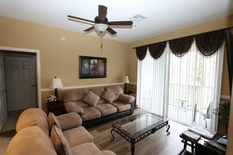 Lounge area with comfy sofas, patio door to balcony