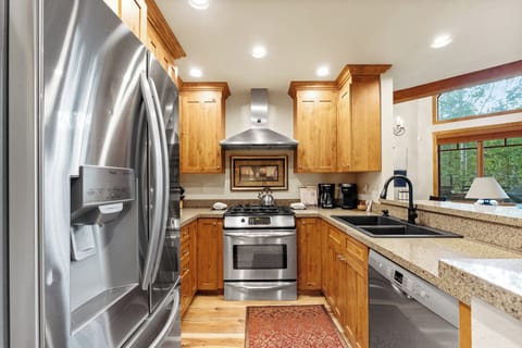 Full size kitchen with granite countertops new hardwood flooring and stainless steel appliances throughout.