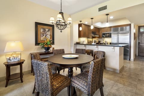 Dining area with wicker chairs and high table.