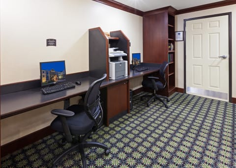 Quiet business center with two computers and a printer.