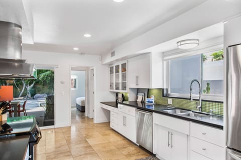 View from kitchen to hallway with bedroom and 1/2 bathroom. 