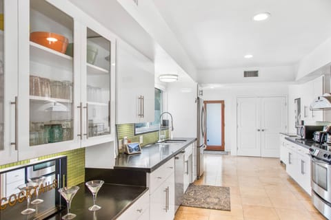 Kitchen is stocked with appliances, dishes, utensils and cooking basics.  