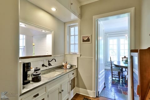 Butler's pantry with carafe and pod coffee maker on original German steel sink