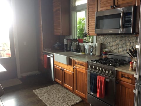 Main cottage kitchen with full-size refrigerator, stove, and dishwasher