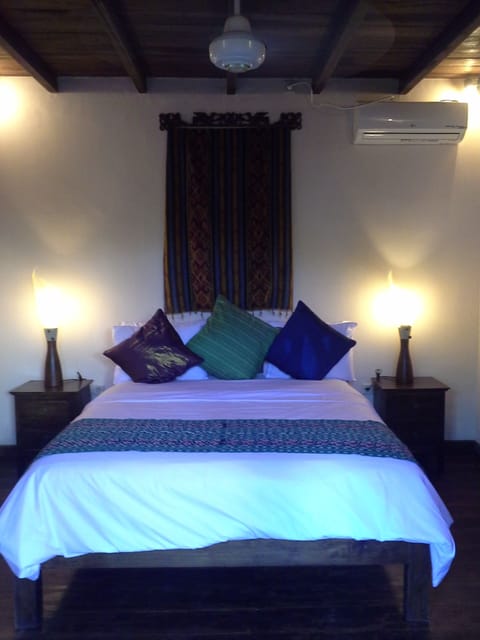 Queen sized bed with pillow-top mattress and teak bed