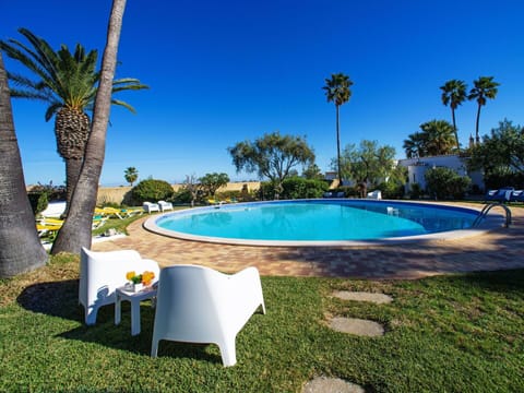 Water, Sky, Plant, Swimming Pool, Building, Azure, Tree, Shade, Outdoor Furniture, Arecales
