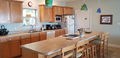 Just off the kitchen is a full laundry and shelves for your groceries.